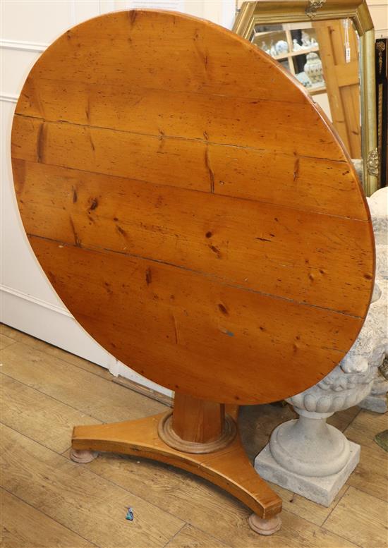 A Victorian circular pine tilt top table W.103cm